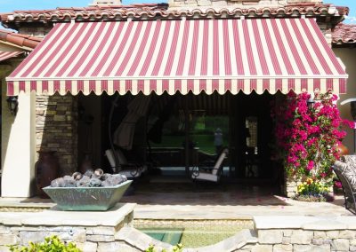 Striped Retractable Awning Over Patio