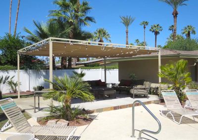Backyard free standing patio cover by pool